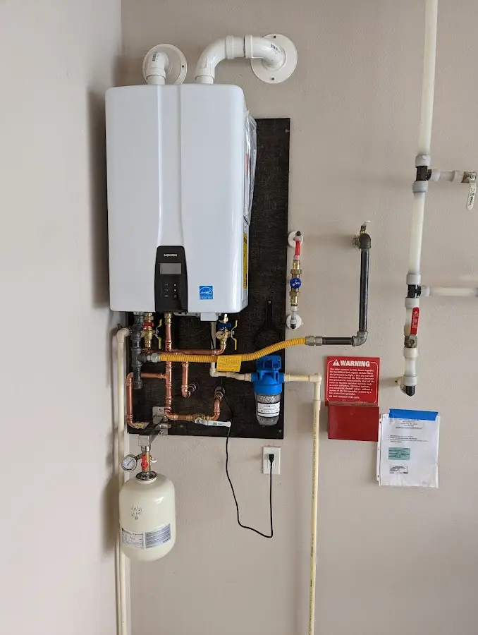 Professional plumber installing copper piping in a Bethel Acres home